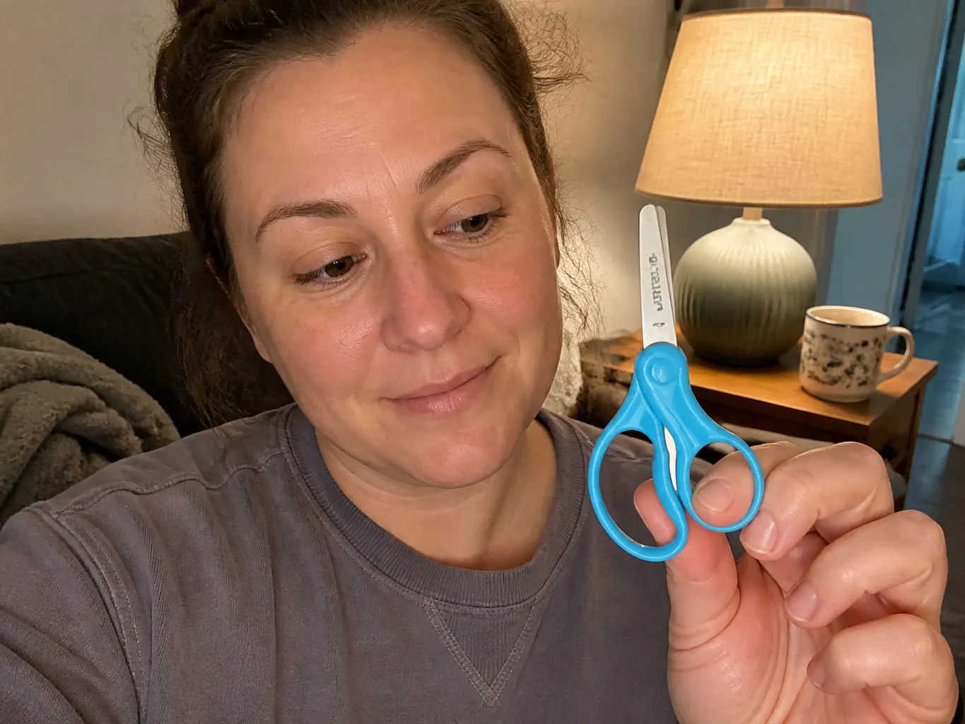 LeftyCut scissors on a kitchen table beside cut paper shapes