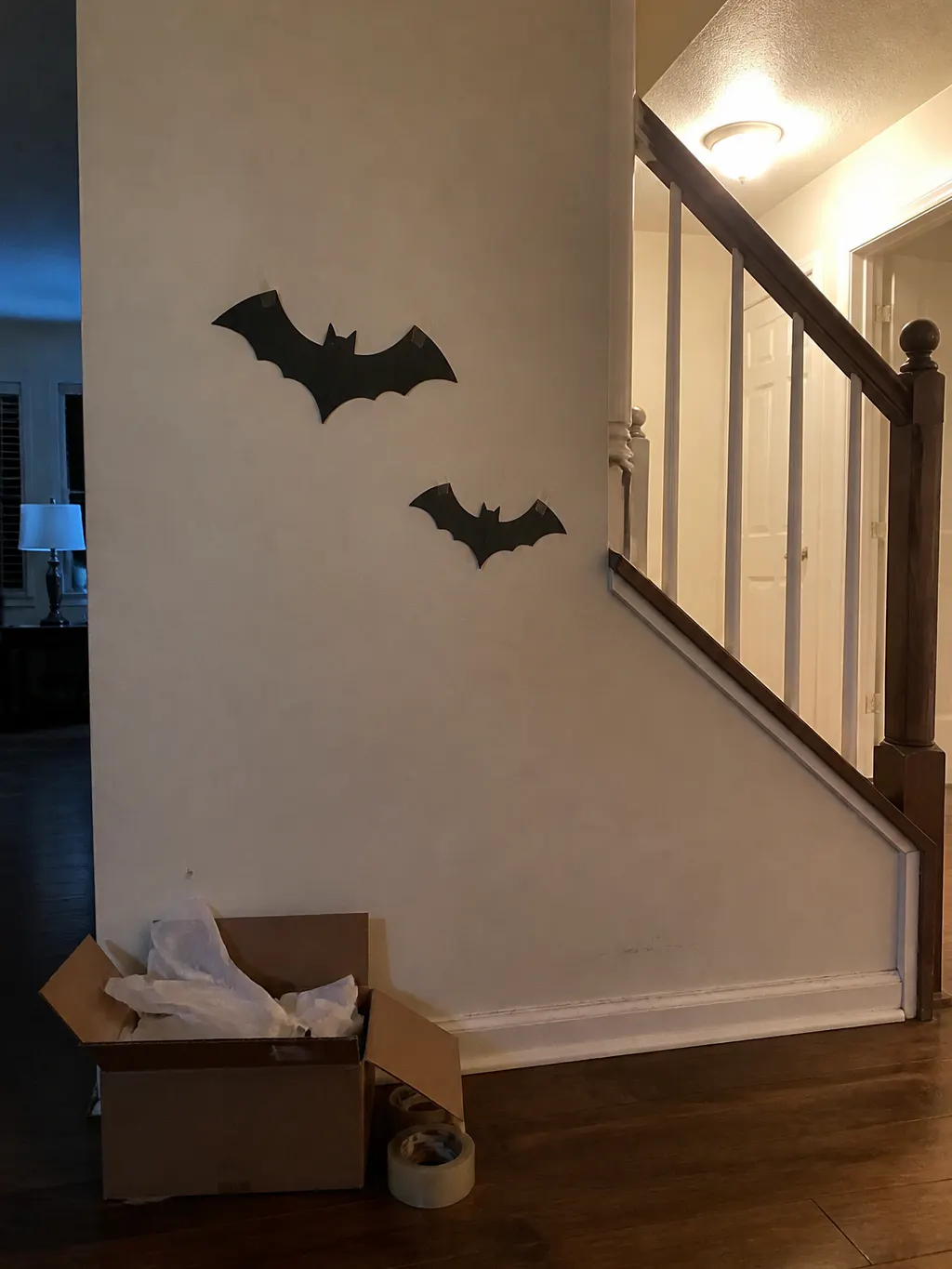 Flat black bat cutouts disappearing into a dim wall