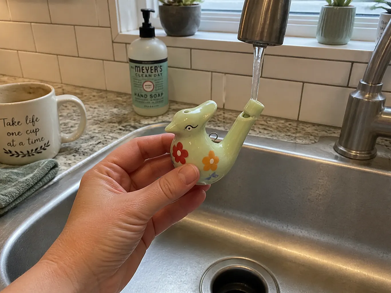 Tap water filling the ceramic bird to the one-third line