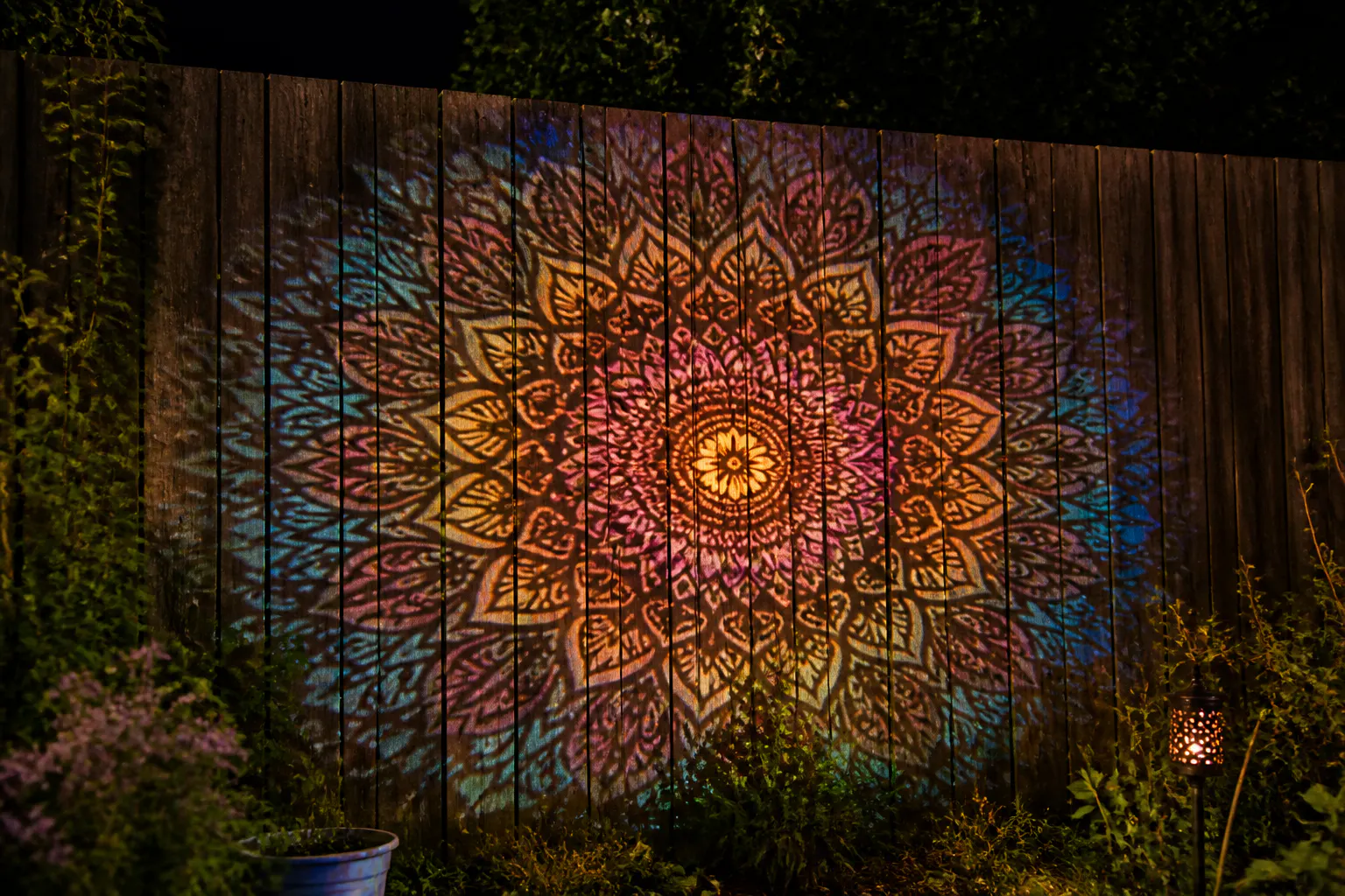 Crisp laser-cut mandala pattern projected on the fence
