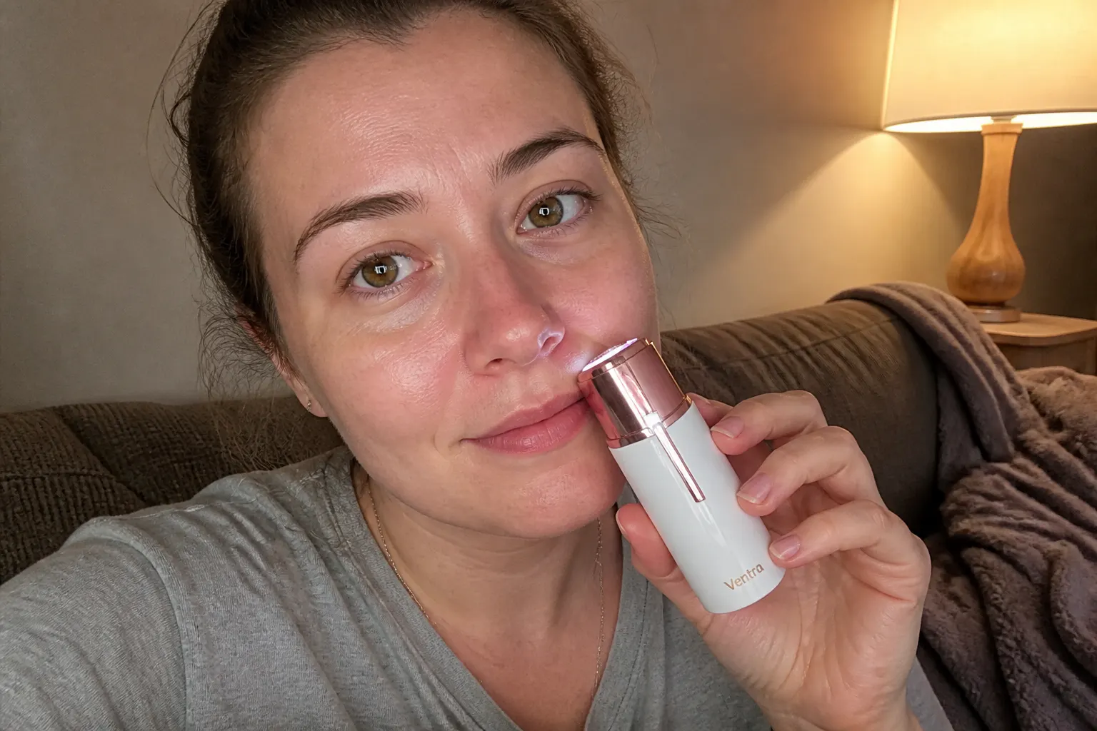 The rose-gold trimmer resting on a luxe blush vanity