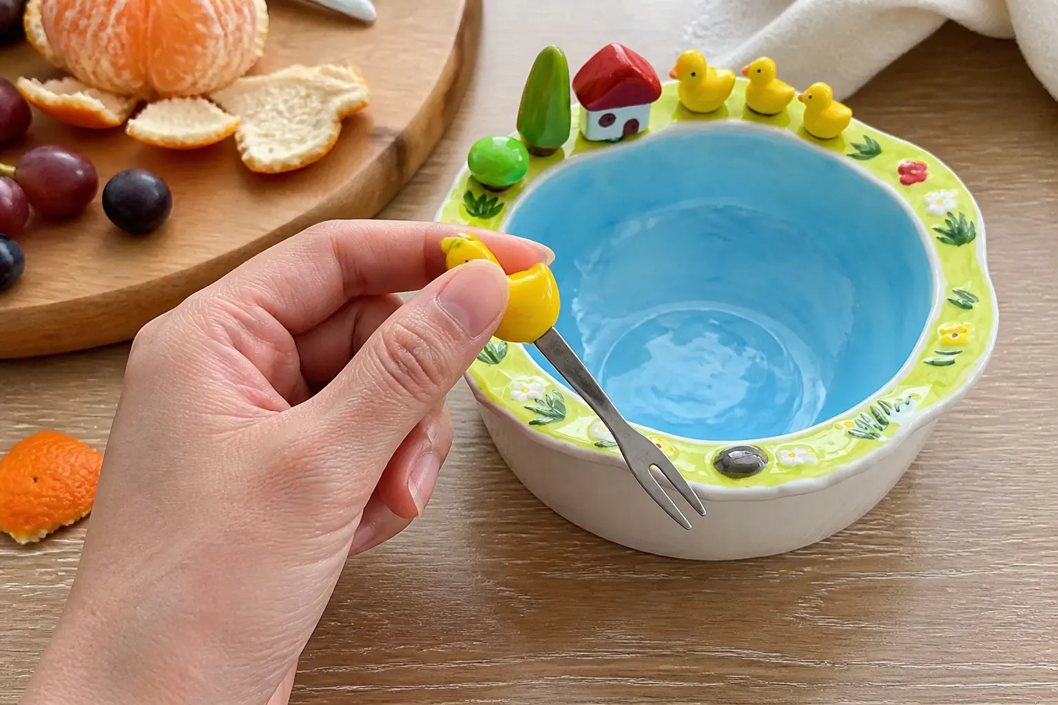 Close-up of a duck-handled fork topped with a ceramic duck figurine