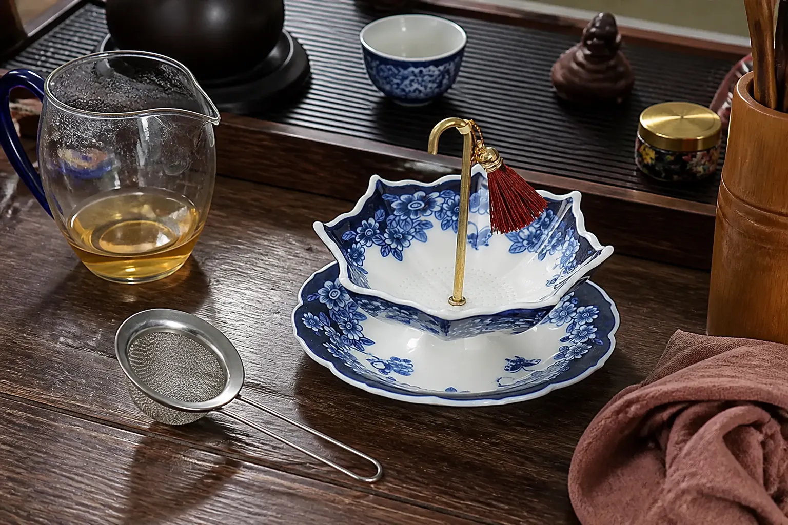A carefully styled tea corner undercut by a plain steel mesh strainer