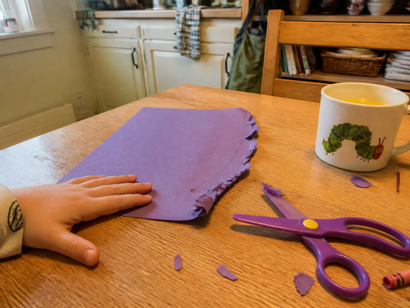 Paper crumpled and snagged by dull plastic trainer scissors