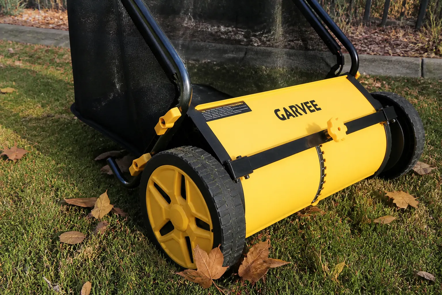Steel-frame push lawn sweeper in a yard