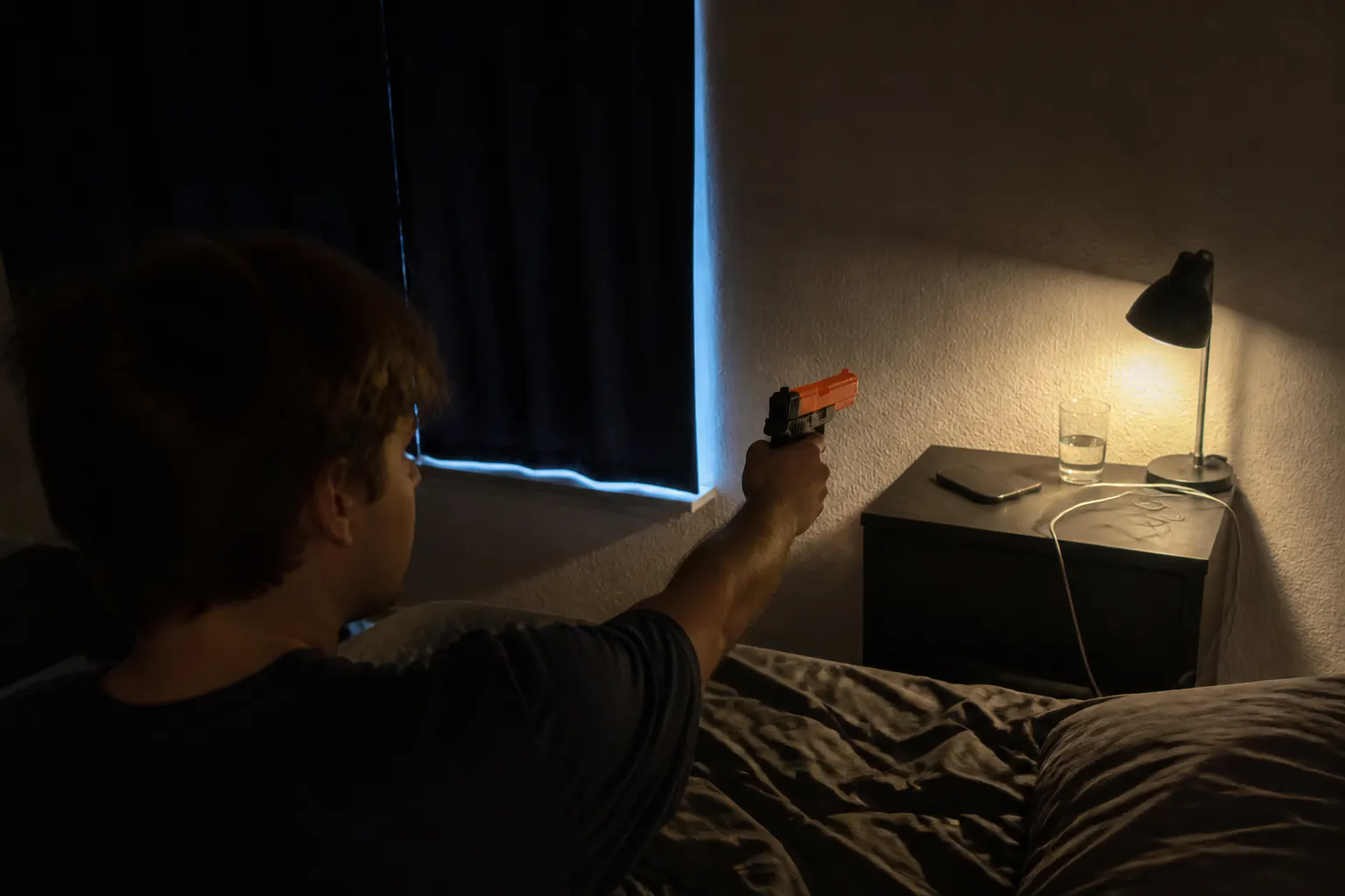 Dark bedroom at dawn, aiming the gun at the alarm clock