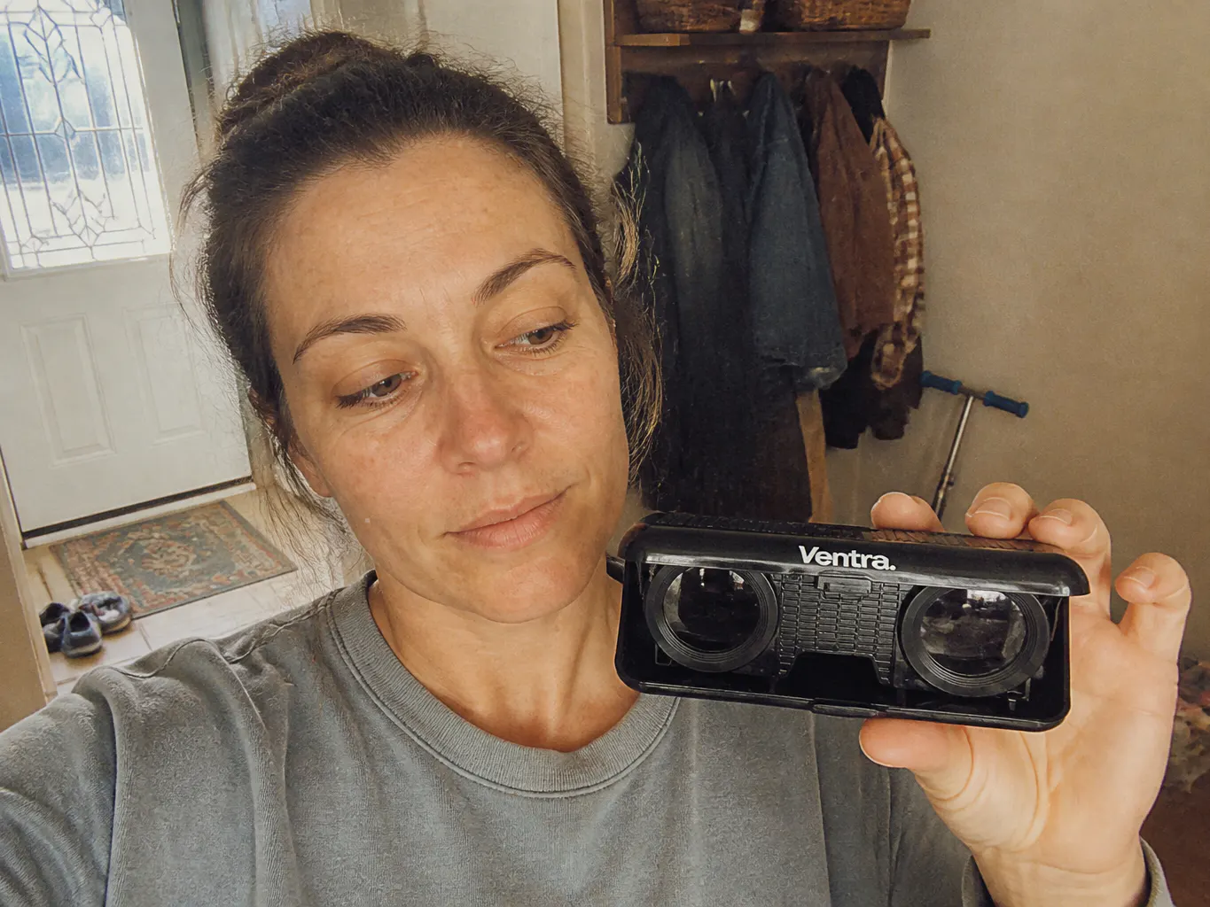 The camera case on a kitchen counter next to a jacket