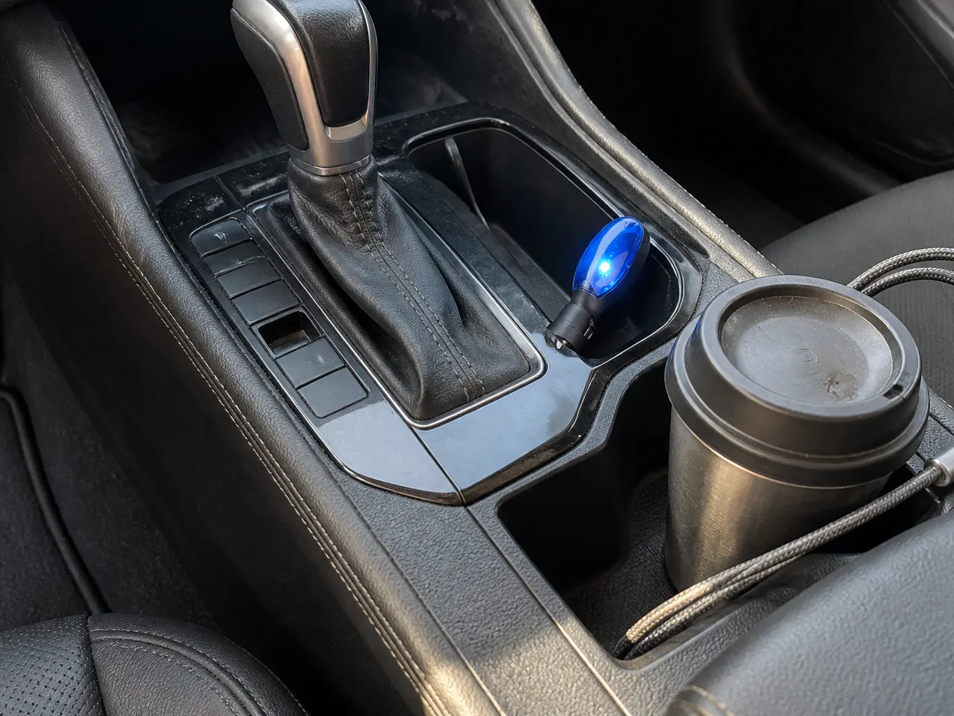 The Mileage Chip seated in a vehicle 12V accessory socket at dusk