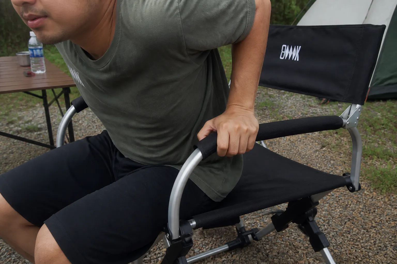 Sarah M. using the chair outdoors