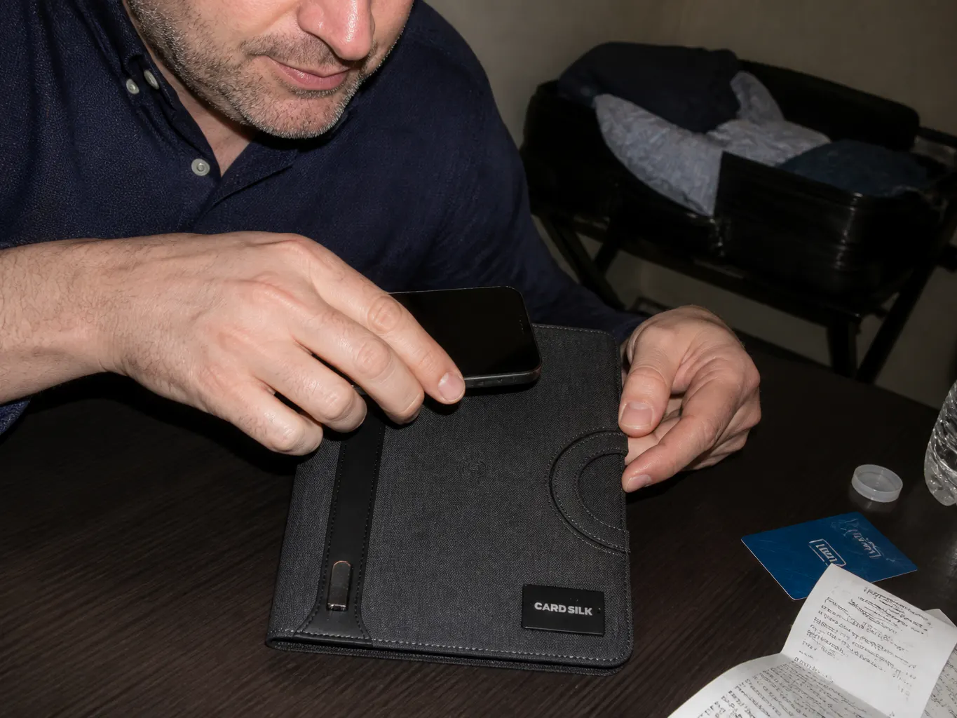 The open case on a desk with the cable bay visible and a notepad clipped in