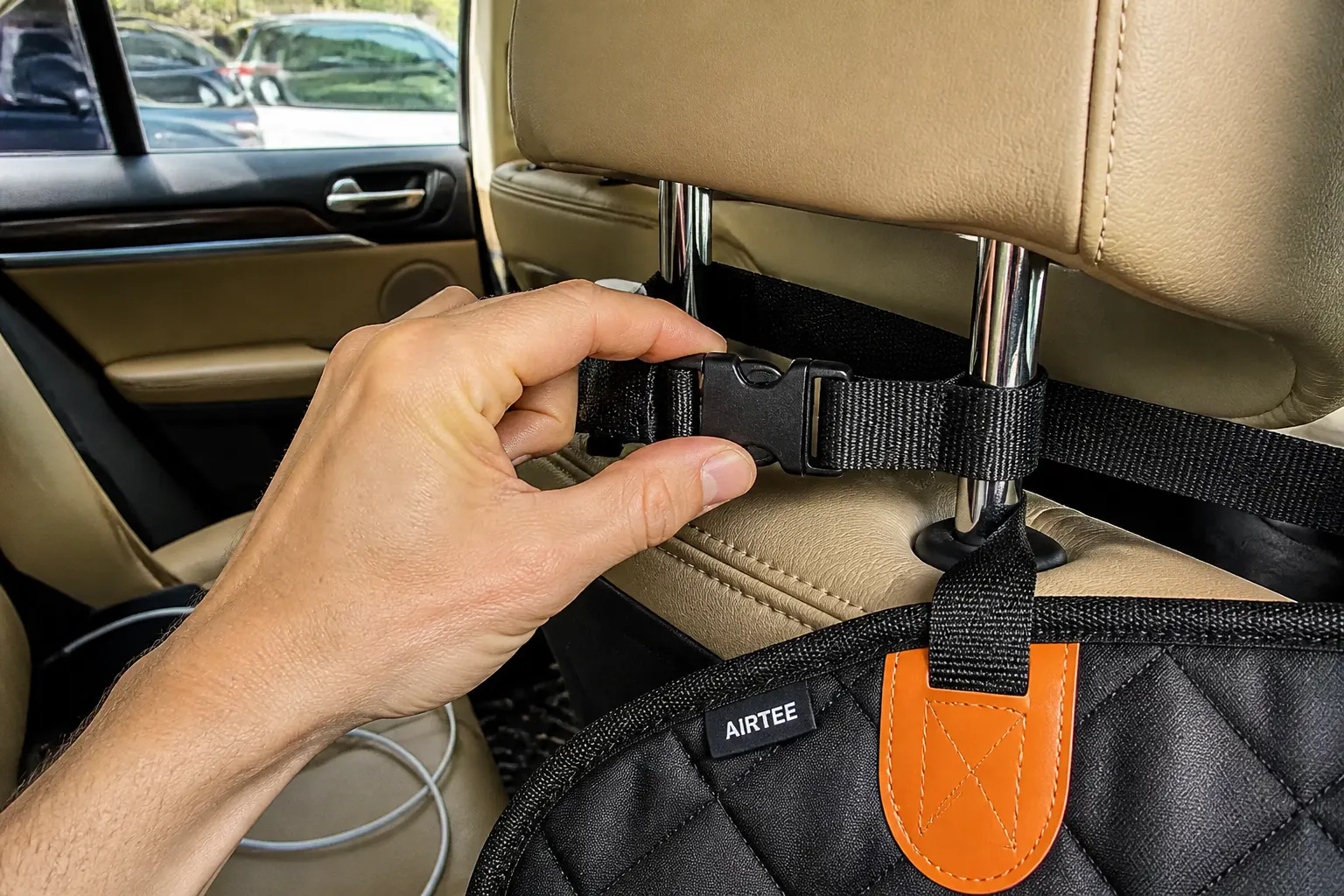Adjustable strap buckled over an SUV headrest anchoring the cover