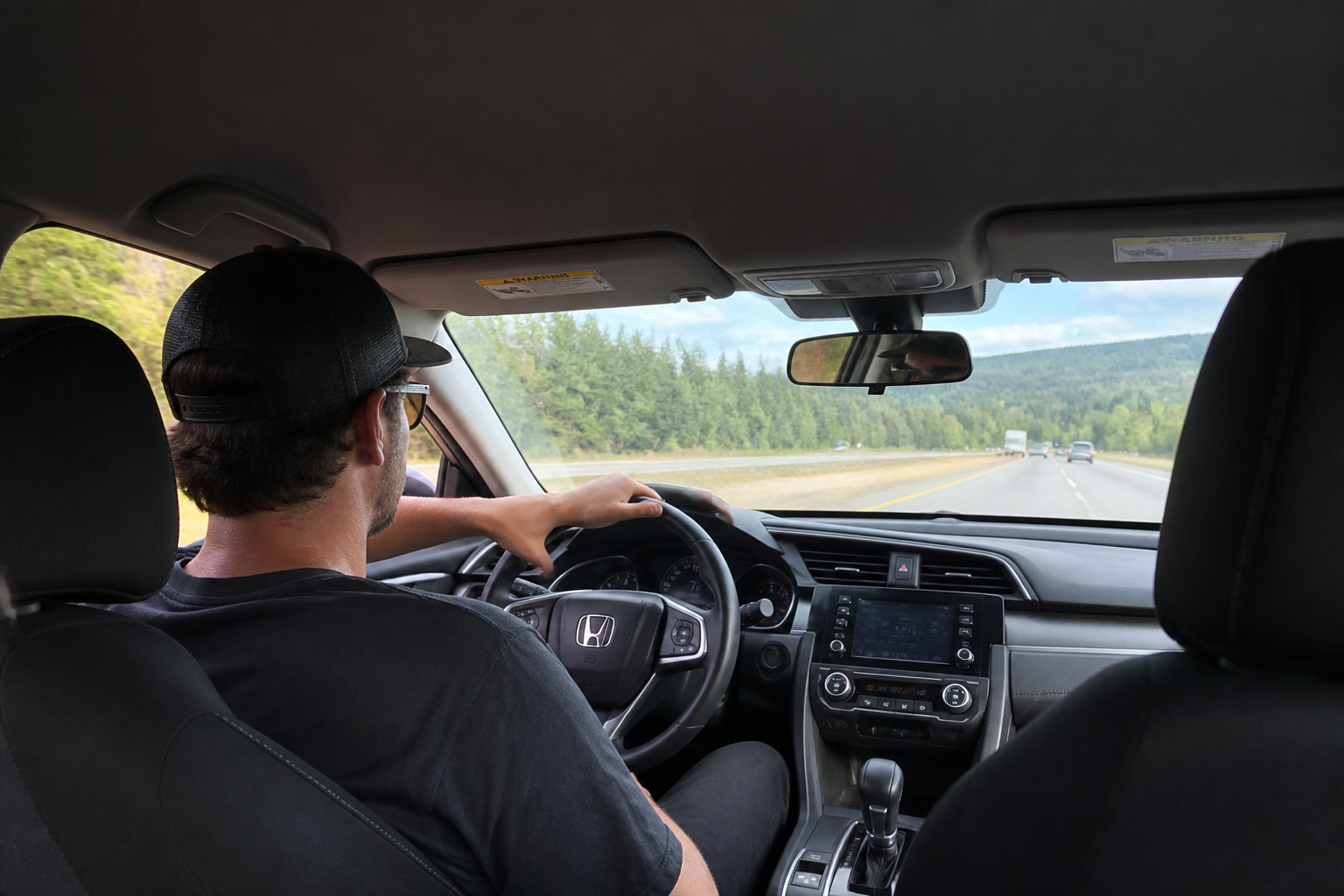 Driver relaxed on a long drive with a supported arm