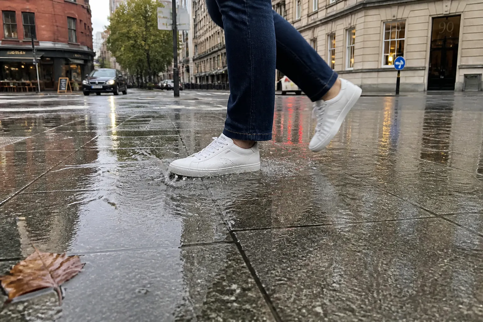 A person walking through rain with dry feet thanks to Ventra shoe covers