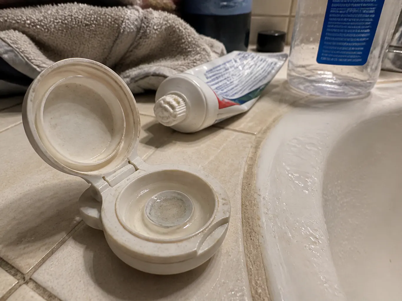 Scratched plastic lens case beside the Ventra chambers on a bathroom shelf