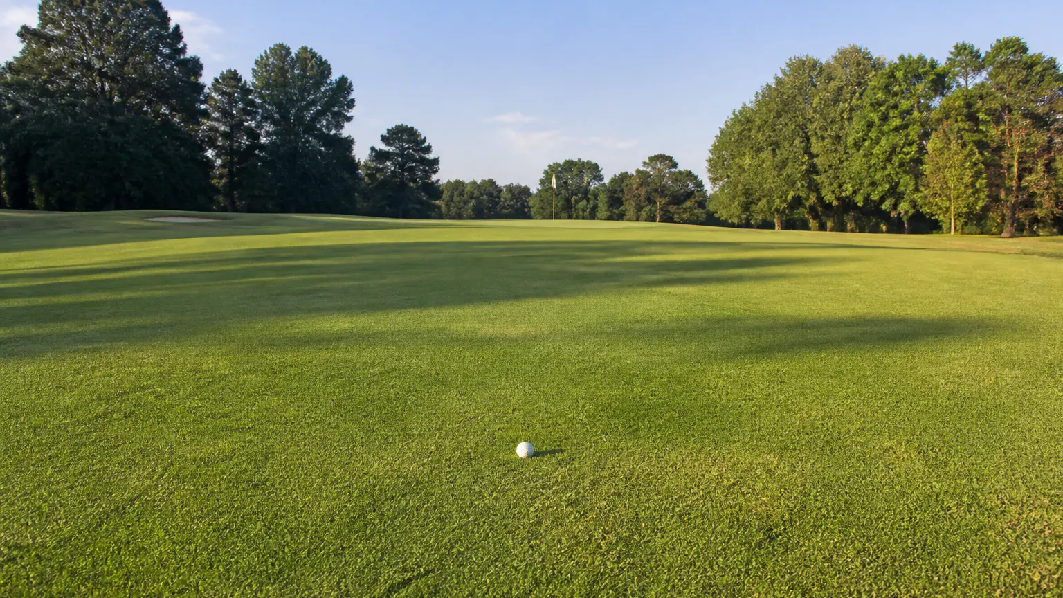 Golfer walking straight to his ball, round moving