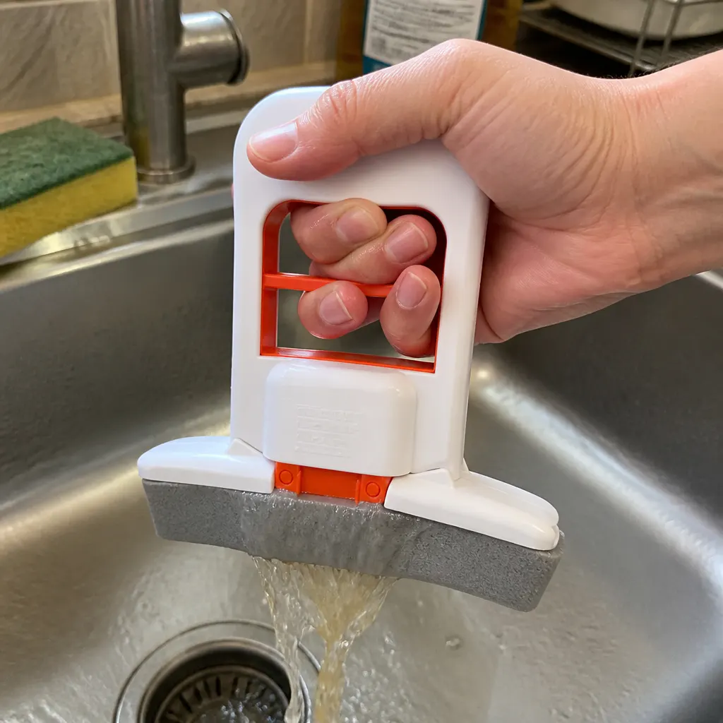 Mini mop being squeezed, dirty water streaming into the sink