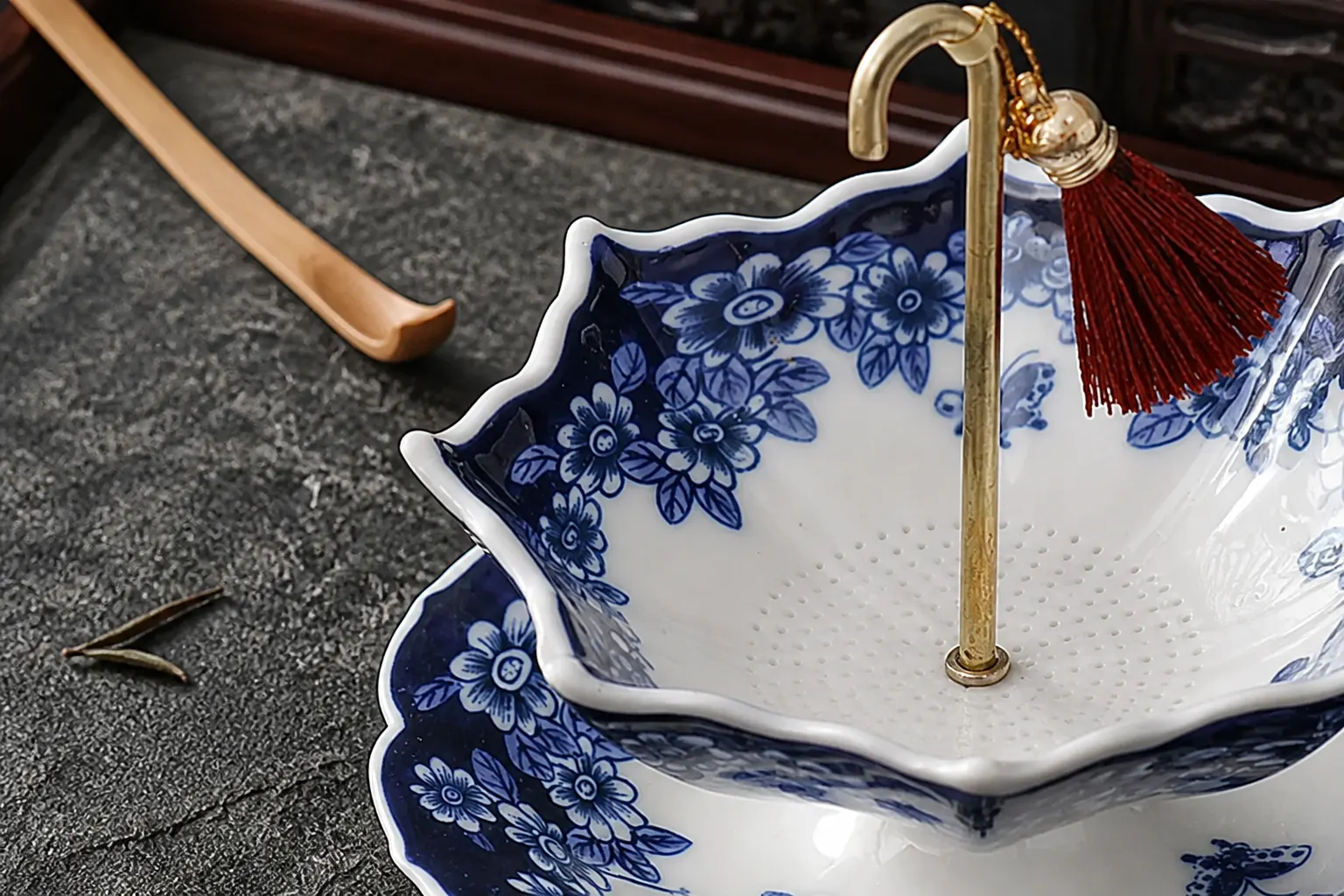 Close-up of the hand-painted blue-and-white porcelain umbrella tea strainer