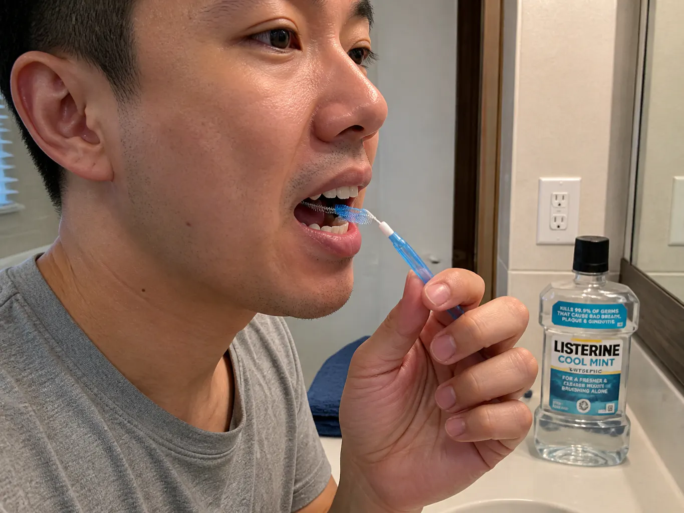 Interdental brush gently inserted between two teeth