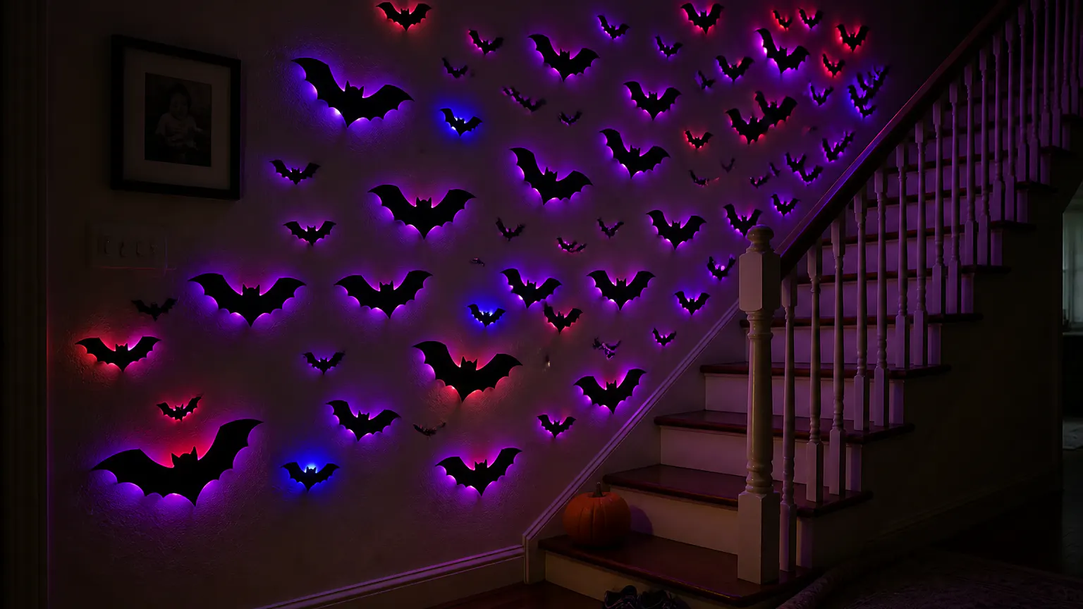 The finished staircase wall at night, the full swarm lit violet, a figure paused mid-step