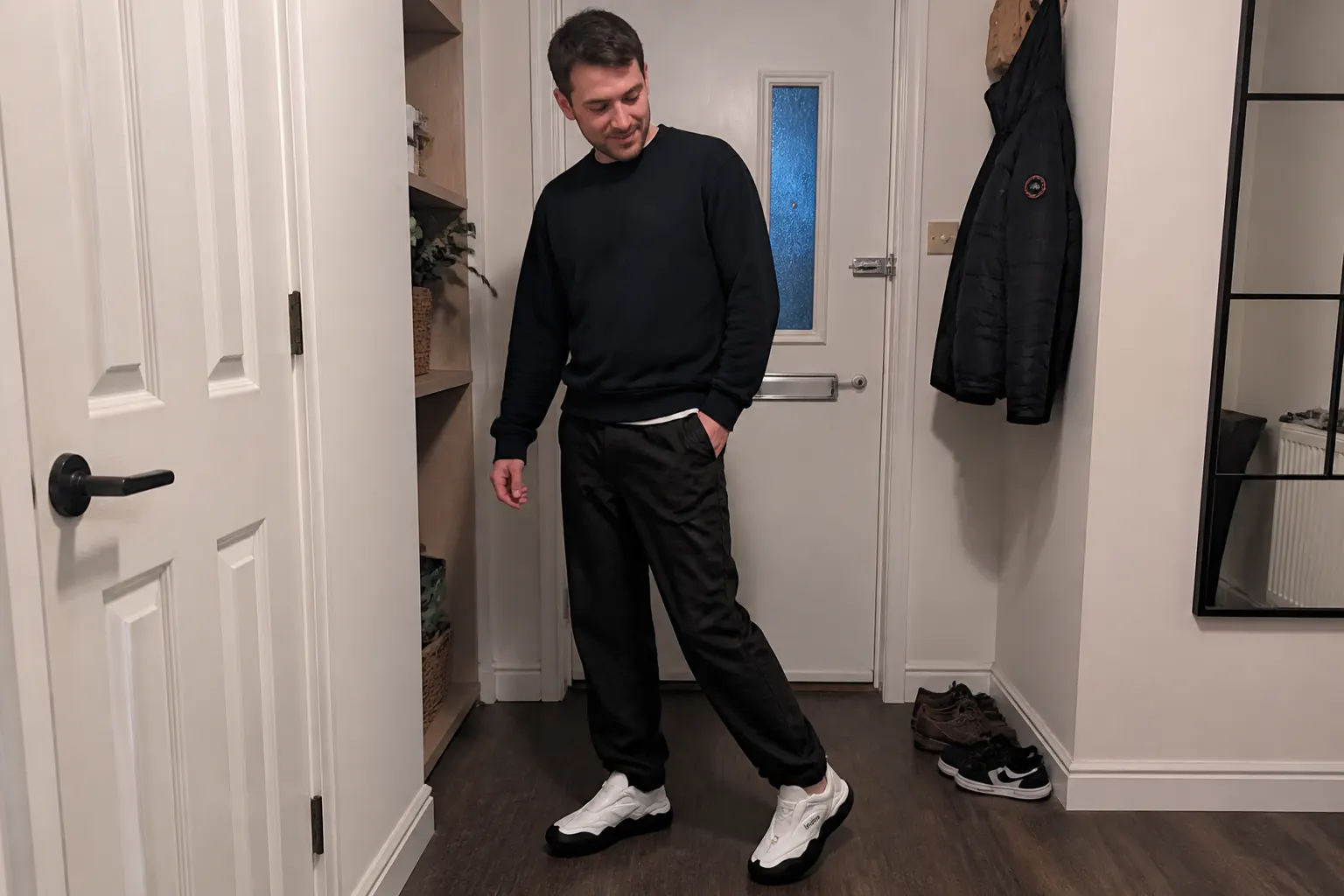 Matte-black CleatShield fitted on football boots worn with jeans