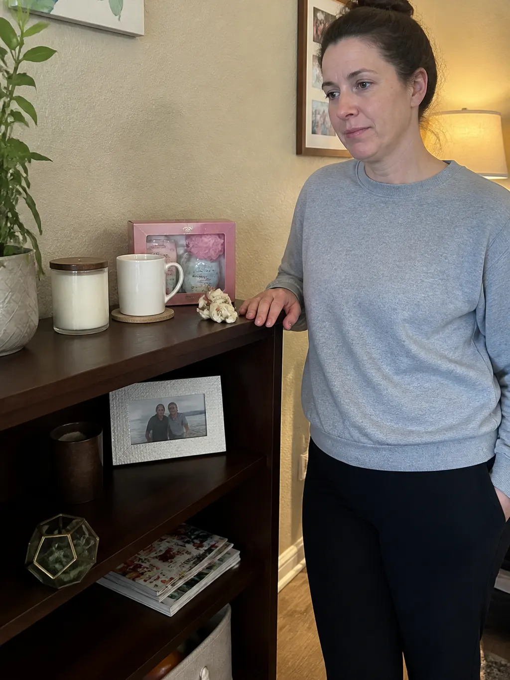A warm cluttered desk with an open laptop showing a gift guide, the ceramic bird sitting beside it