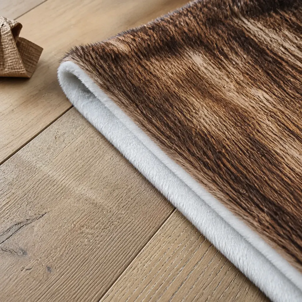 Extreme close-up of the folded blanket edge showing the printed fleece face bonded to the sherpa reverse