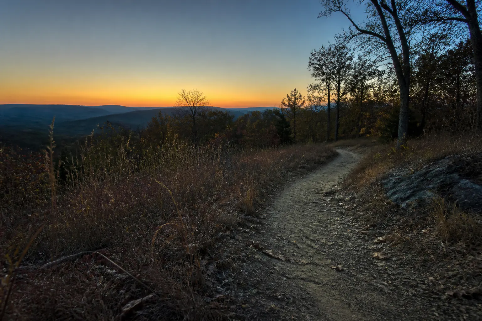A family on a trail at dusk, adventure continuing