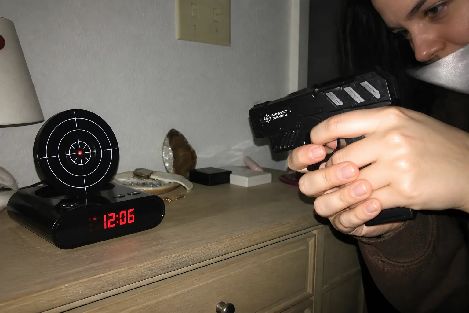 The clock and gun on a customer's dresser