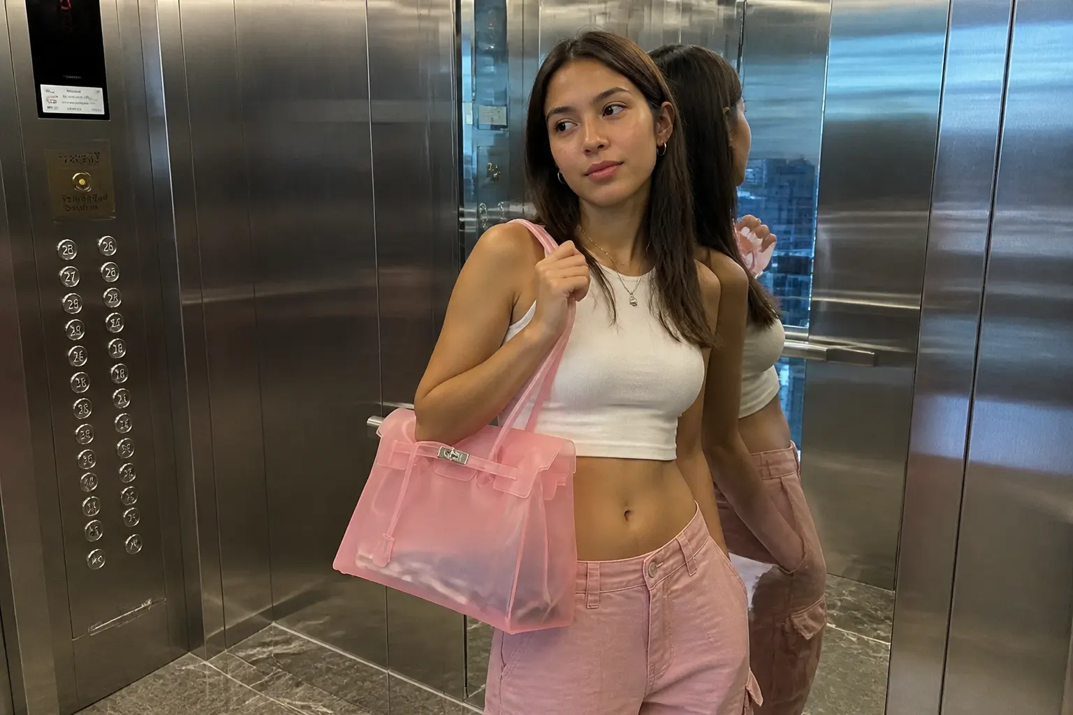 Translucent jelly Birkin tote held at the side