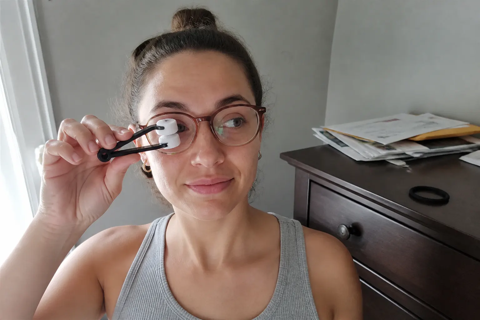The tool held up to a pair of sunglasses in a car