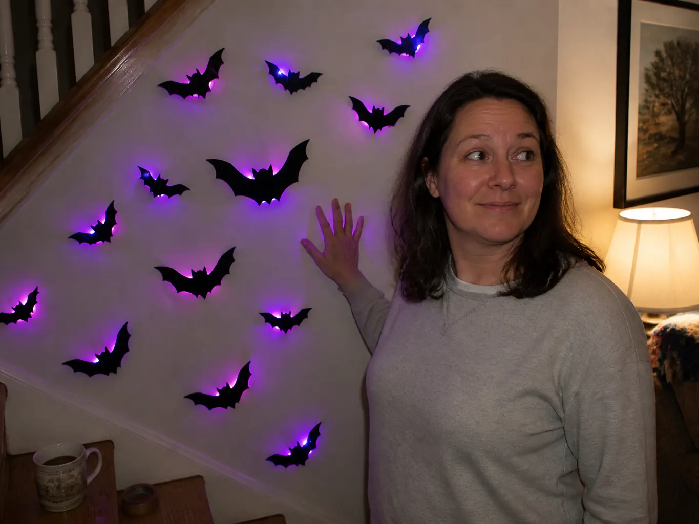 Lit bats climbing a customer's staircase wall