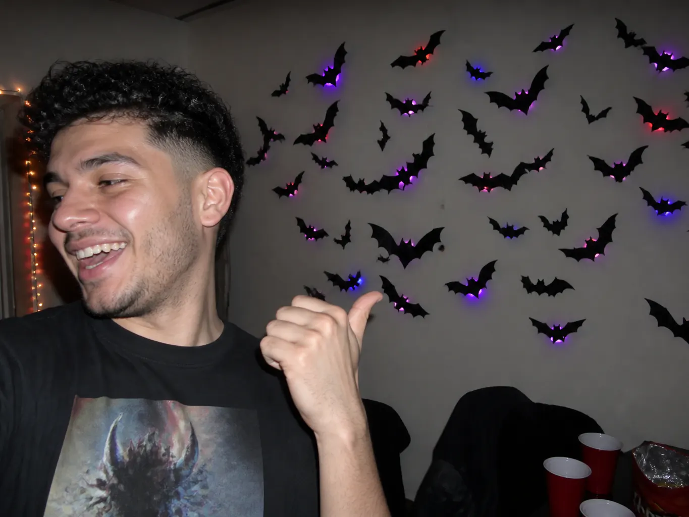 Glowing bats scattered along a hallway wall at night