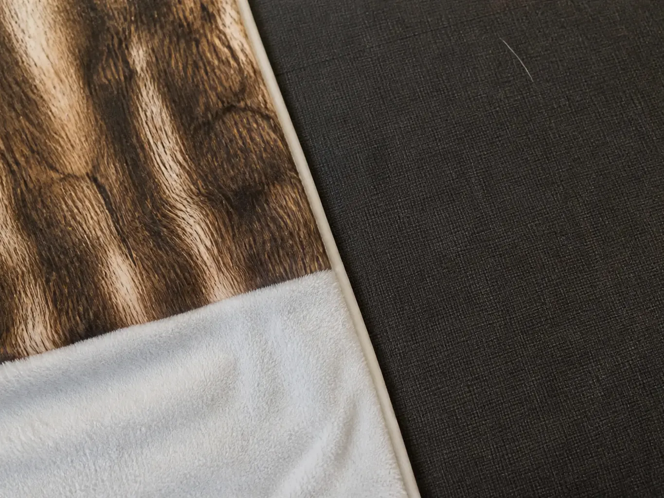 The hide pattern shown against a dark sofa fabric