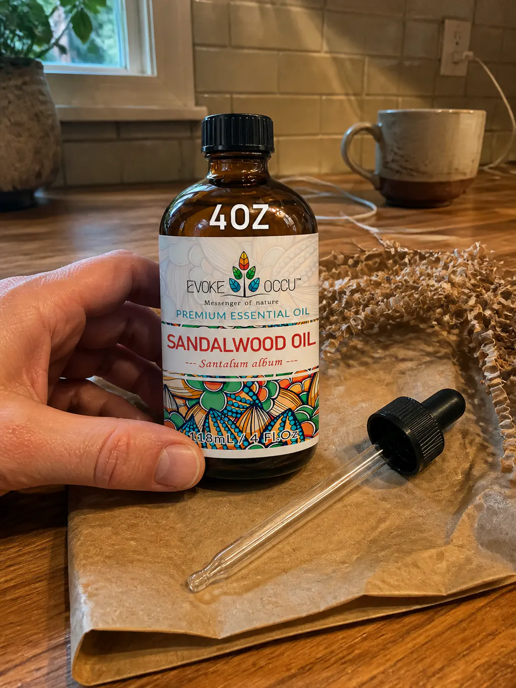 The sealed amber bottle and intact glass dropper lifted from protective packaging