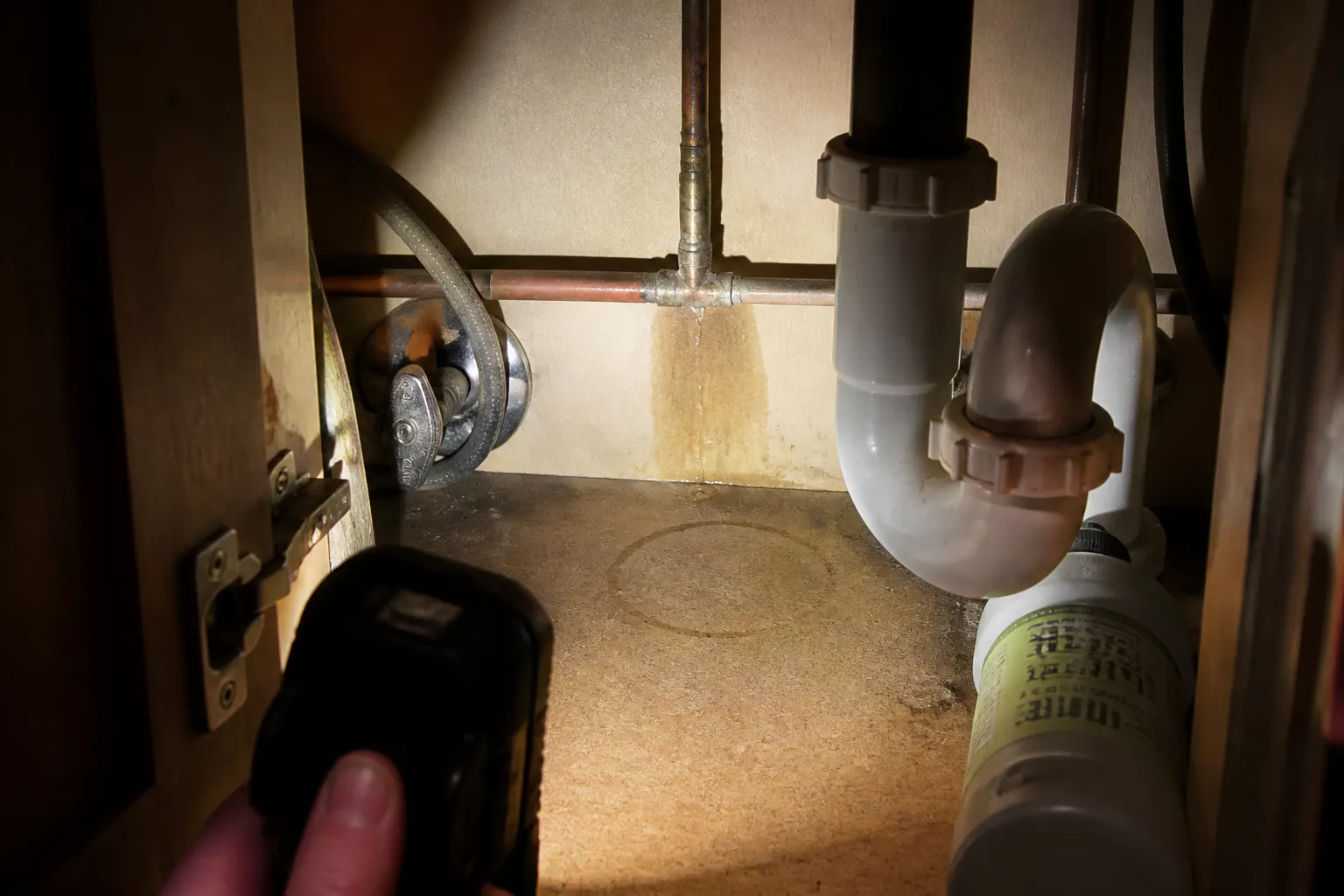Person holding a phone showing a clear HD image from inside a wall, finally seeing the source of the problem