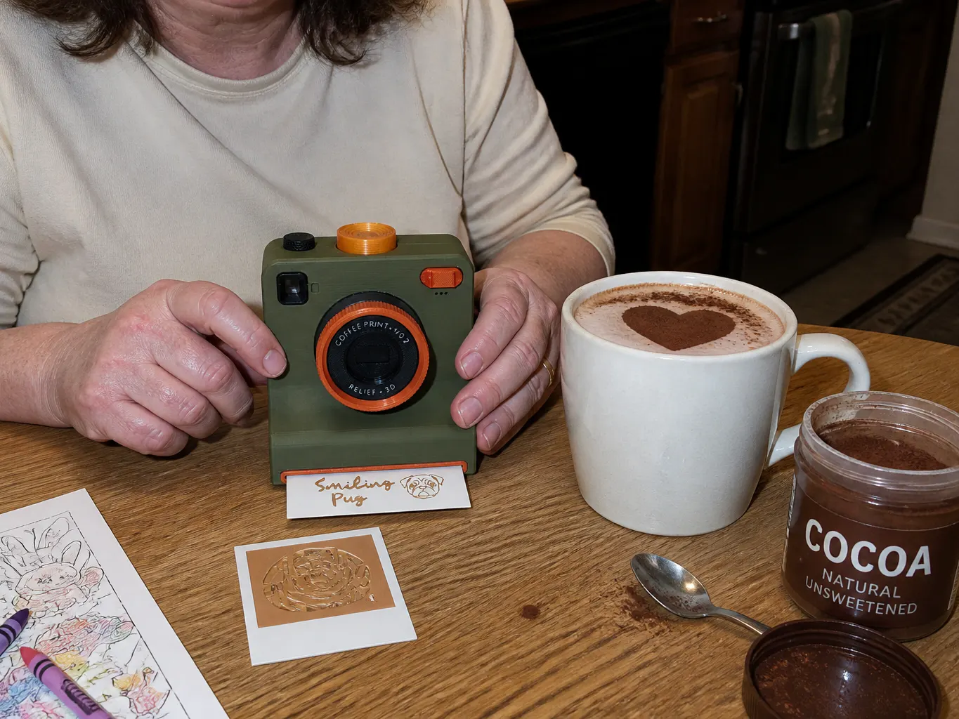 A supermarket cocoa tin beside the camera on a kitchen worktop