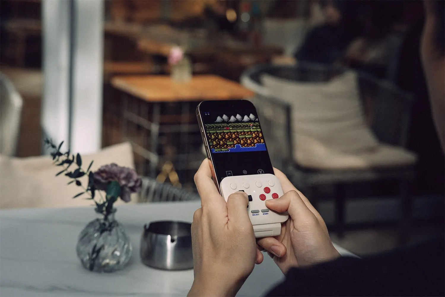 The controller flipped open on a phone at rest, game running