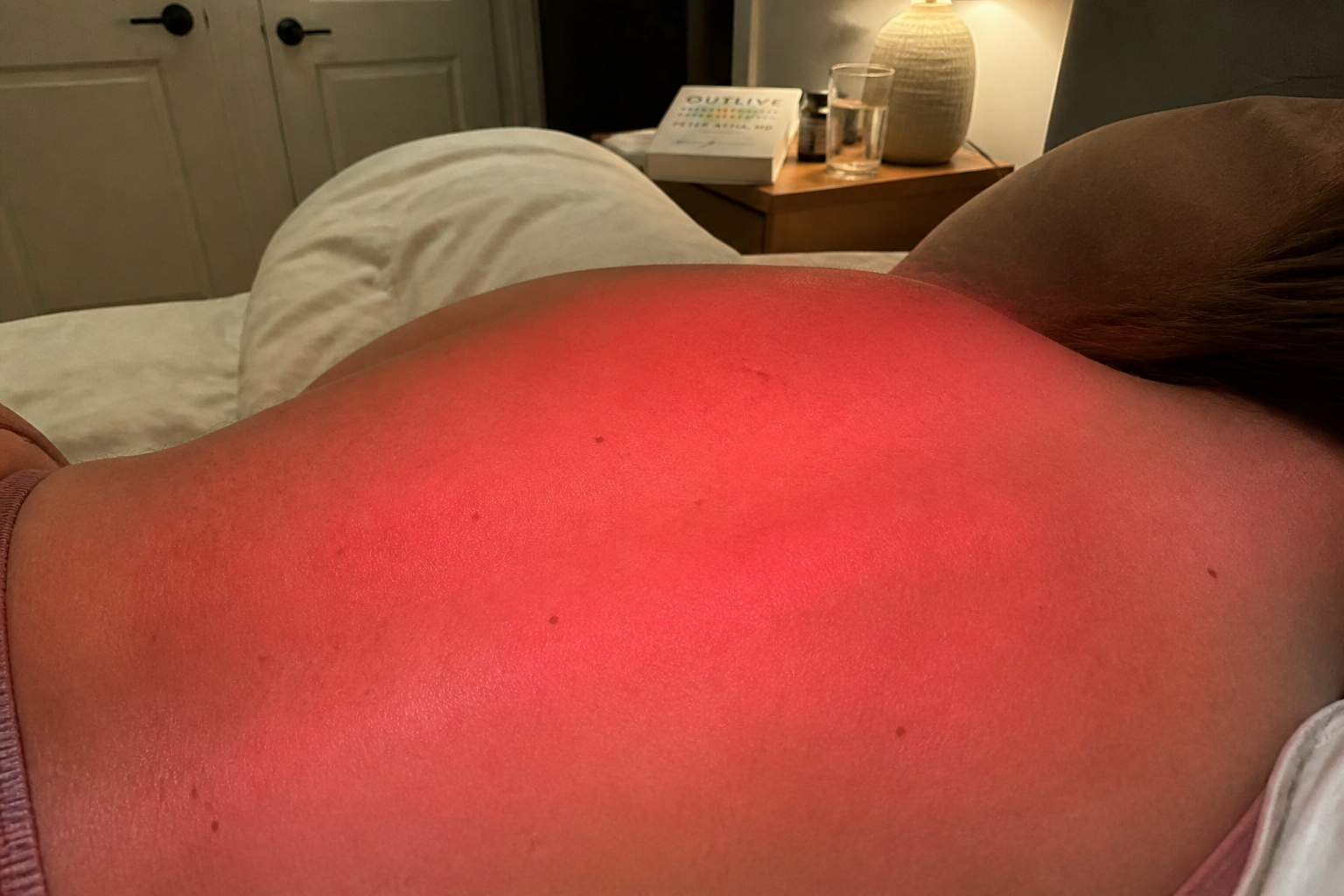 Close-up of the red light mat glowing against a reclined back